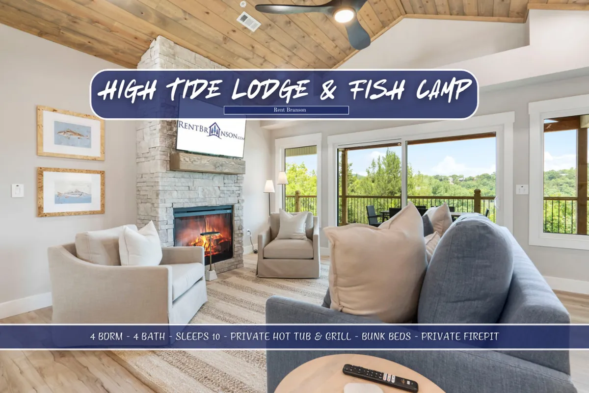 A cozy, open-concept living area with a majestic floor-to-ceiling stone fireplace as the central focal point. Plush, comfortable seating is arranged around the fireplace, and large windows invite natural light into the space. The setting is perfect for group gatherings, story sharing, and relaxing evenings.