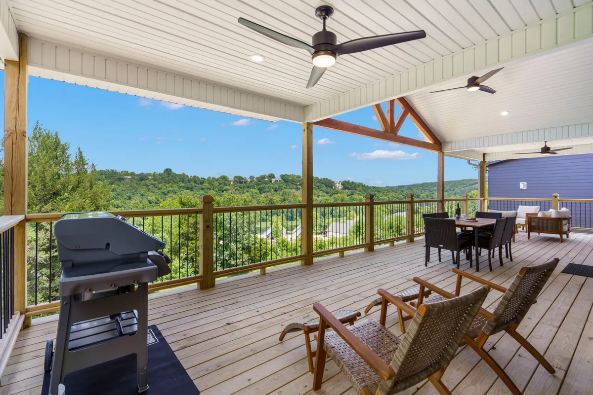 An inviting outdoor dining area complete with a grill, ample seating, and scenic views over the landscape and hills. The setup hints at group barbecues and sunset gatherings, reflecting the social and scenic elements alluded to in the description.